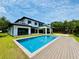 Modern two-story home features a backyard with a pool and a wood deck at 182 N Phelps Ave, Winter Park, FL 32789