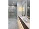 Contemporary bathroom features double sinks, floating vanity with underlighting, and stylish sconces and mirrors at 182 N Phelps Ave, Winter Park, FL 32789