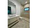 Bathroom with marble floors, floating vanity, and glass shower at 182 N Phelps Ave, Winter Park, FL 32789