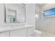 Bright bathroom with a vessel sink, stone countertop, frameless glass shower and a square window at 182 N Phelps Ave, Winter Park, FL 32789