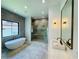 Bathroom featuring a tub, walk-in shower, double vanity, mosaic wall and granite countertop at 182 N Phelps Ave, Winter Park, FL 32789