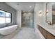 This primary bathroom offers a luxurious soaking tub, a glass-enclosed shower and dual sink vanity at 182 N Phelps Ave, Winter Park, FL 32789