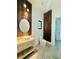 Modern bathroom showcasing stone vanity, vessel sink, custom wood accent wall, and marble flooring at 182 N Phelps Ave, Winter Park, FL 32789