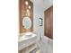 Stylish powder room with decorative wall paneling, and a modern sink at 182 N Phelps Ave, Winter Park, FL 32789