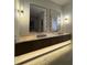 Bathroom with a double vanity with granite counters, decorative mirrors and lighting at 182 N Phelps Ave, Winter Park, FL 32789