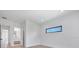 Light-filled bedroom with hardwood floors and a transom window at 182 N Phelps Ave, Winter Park, FL 32789