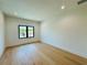 Minimalist bedroom with hardwood flooring, black window frames, and bright natural light at 182 N Phelps Ave, Winter Park, FL 32789