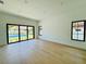Large bedroom with hardwood floors and sliding doors offering natural light and pool views at 182 N Phelps Ave, Winter Park, FL 32789