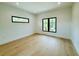 An empty room with hardwood floors, black trim windows, and recessed lighting gives a clean, modern style at 182 N Phelps Ave, Winter Park, FL 32789