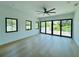Sunlit bedroom with hardwood flooring and windows and doors allowing access to a deck at 182 N Phelps Ave, Winter Park, FL 32789