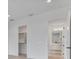 Spacious bedroom features a closet and bathroom entrances, with white walls, and light wood floors at 182 N Phelps Ave, Winter Park, FL 32789
