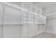 Spacious walk-in closet with custom shelving, drawers, and hanging rods at 182 N Phelps Ave, Winter Park, FL 32789