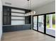 Elegant dining area with custom built-ins, modern lighting, and backyard views for sophisticated gatherings at 182 N Phelps Ave, Winter Park, FL 32789