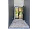 Inviting front entrance featuring modern black frame glass doors and stone tile floor, creating a grand arrival at 182 N Phelps Ave, Winter Park, FL 32789