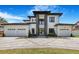 Stunning two-story home featuring a modern design, three-car garage, and beautifully landscaped front yard at 182 N Phelps Ave, Winter Park, FL 32789