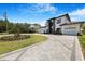 Beautifully landscaped two-story home with a three-car garage and modern architectural design at 182 N Phelps Ave, Winter Park, FL 32789