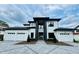 Stunning modern home with a three-car garage, a geometric paver driveway and professional landscaping at 182 N Phelps Ave, Winter Park, FL 32789