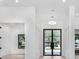 Bright foyer showcases soaring ceilings, modern lighting, and expansive views of the property's exterior at 182 N Phelps Ave, Winter Park, FL 32789