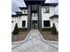 Impressive modern home with glass front door, black accents, and a geometric paver walkway at 182 N Phelps Ave, Winter Park, FL 32789