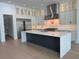 Kitchen features a large island, stainless appliances, and ample custom cabinet storage at 182 N Phelps Ave, Winter Park, FL 32789