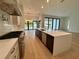 Gourmet kitchen showcases a large island, stainless appliances, and easy access to backyard pool for outdoor living at 182 N Phelps Ave, Winter Park, FL 32789