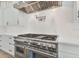 Close-up of a gourmet kitchen featuring a professional-grade stovetop and exhaust hood at 182 N Phelps Ave, Winter Park, FL 32789