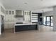 Bright and spacious kitchen boasts stainless steel appliances, custom cabinetry, and a large center island at 182 N Phelps Ave, Winter Park, FL 32789