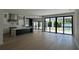 Open kitchen and living area with sliding glass doors leading to the outdoor pool at 182 N Phelps Ave, Winter Park, FL 32789