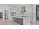 Modern kitchen features white cabinets, stainless steel appliances, and a large island at 182 N Phelps Ave, Winter Park, FL 32789