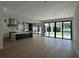 Bright open living area flows to kitchen, featuring hardwood floors and large sliding glass doors to backyard pool at 182 N Phelps Ave, Winter Park, FL 32789