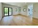 Bright living room showcasing hardwood floors and modern windows, creating a seamless, airy space at 182 N Phelps Ave, Winter Park, FL 32789