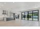 Bright open-concept living area with modern stainless steel appliances, island, and large sliding glass doors at 182 N Phelps Ave, Winter Park, FL 32789