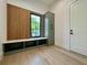Mud room features a window bench, wood accent wall and olive green storage at 182 N Phelps Ave, Winter Park, FL 32789