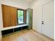 Mudroom with built-in bench, storage cabinets, and window at 182 N Phelps Ave, Winter Park, FL 32789