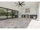 Outdoor kitchen under covered patio with high-end stainless steel grill and bar seating at 182 N Phelps Ave, Winter Park, FL 32789