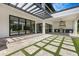 Covered patio with an outdoor kitchen, pavers, and direct access to the manicured yard and pool area at 182 N Phelps Ave, Winter Park, FL 32789
