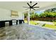 Covered outdoor kitchen featuring high-end grill, vent hood, and a serene backyard view at 182 N Phelps Ave, Winter Park, FL 32789