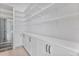 Spacious walk-in pantry with custom shelving and white cabinetry, with a beverage refrigerator at 182 N Phelps Ave, Winter Park, FL 32789