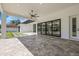 Large covered patio with porcelain tile floors, ceiling fan, and sliding glass doors to the backyard at 182 N Phelps Ave, Winter Park, FL 32789