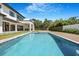 Backyard pool with modern home, outdoor kitchen, travertine pavers and wood deck at 182 N Phelps Ave, Winter Park, FL 32789