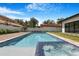 Swimming pool with spa and backyard featuring a manicured lawn, fence for privacy, and modern home at 182 N Phelps Ave, Winter Park, FL 32789