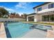 Backyard pool with spa, outdoor landscaping, a modern home, and perimeter fence for privacy at 182 N Phelps Ave, Winter Park, FL 32789