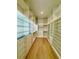 Large walk-in closet with hardwood floor, illuminated display shelves, and custom white storage system at 182 N Phelps Ave, Winter Park, FL 32789