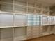 Walk-in closet with custom shelving, drawer units, stylish lighting and ample storage space at 182 N Phelps Ave, Winter Park, FL 32789