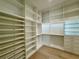 Spacious walk-in closet with custom shelving, drawers, and gold hardware for organizing clothes and accessories at 182 N Phelps Ave, Winter Park, FL 32789
