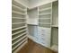 Spacious walk-in closet featuring custom shelving, drawers, and ample storage space at 182 N Phelps Ave, Winter Park, FL 32789
