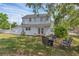 Spacious backyard with patio seating, lush green grass, and a charming two-story home with white siding at 1901 10Th St, St Cloud, FL 34769