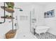 Stylish bathroom featuring a modern shower, clawfoot tub, and unique patterned flooring, filled with natural light at 1901 10Th St, St Cloud, FL 34769