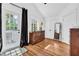 Bright bedroom with hardwood floors, modern decor, and a door leading to a charming outdoor space at 1901 10Th St, St Cloud, FL 34769