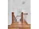 Bright hallway with wood floors and staircase leading to the upper level with natural light from a window at 1901 10Th St, St Cloud, FL 34769